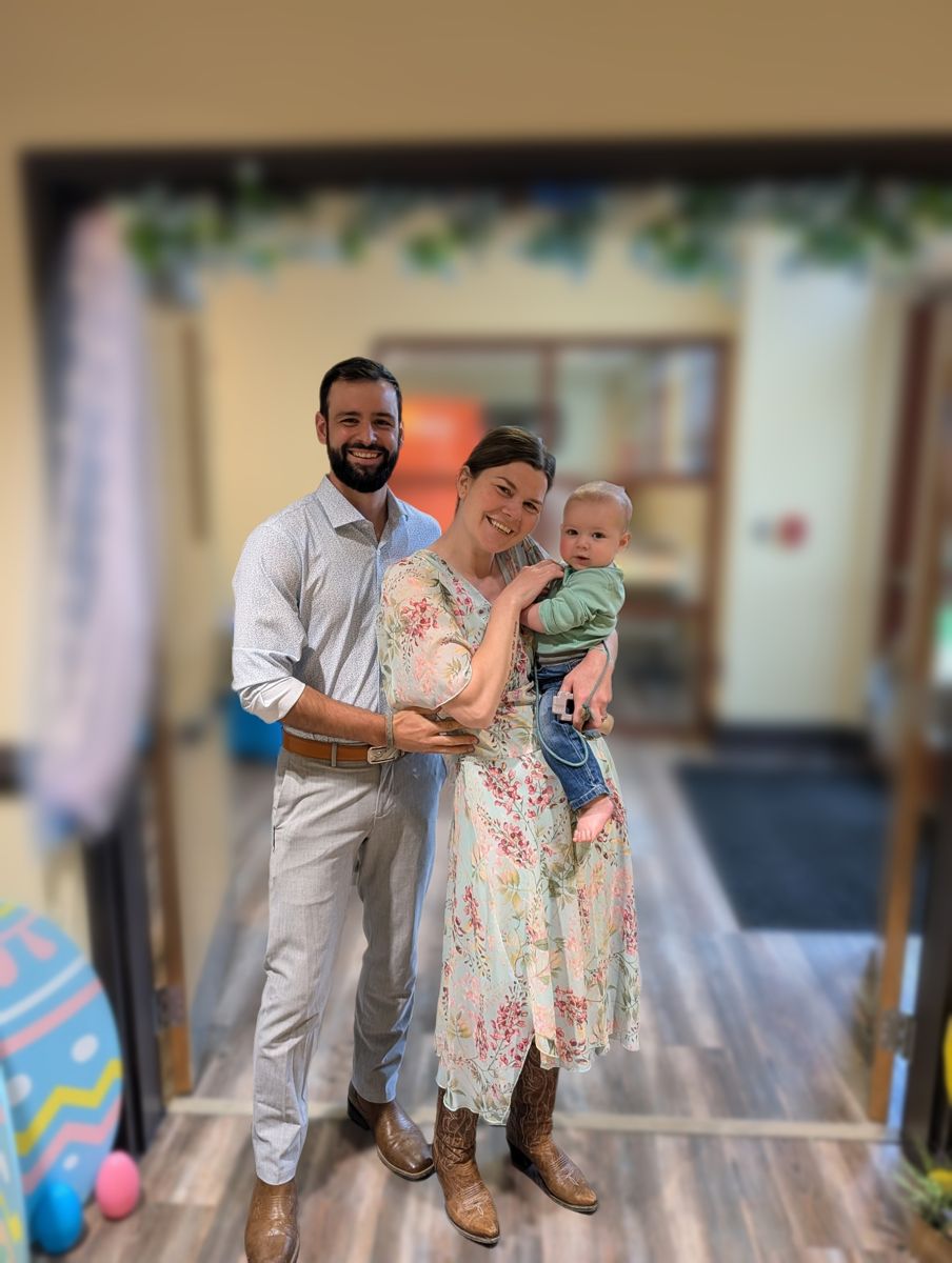 Lucas Redman with his wife and son, dressed up for a family portrait