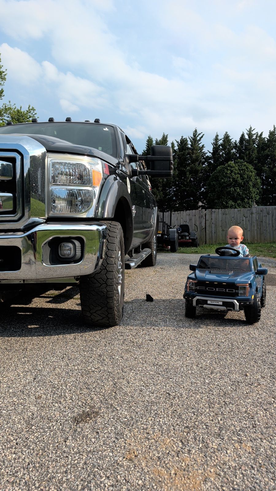 Lucas’s son in a toy Ford truck next to a Ford Super Duty